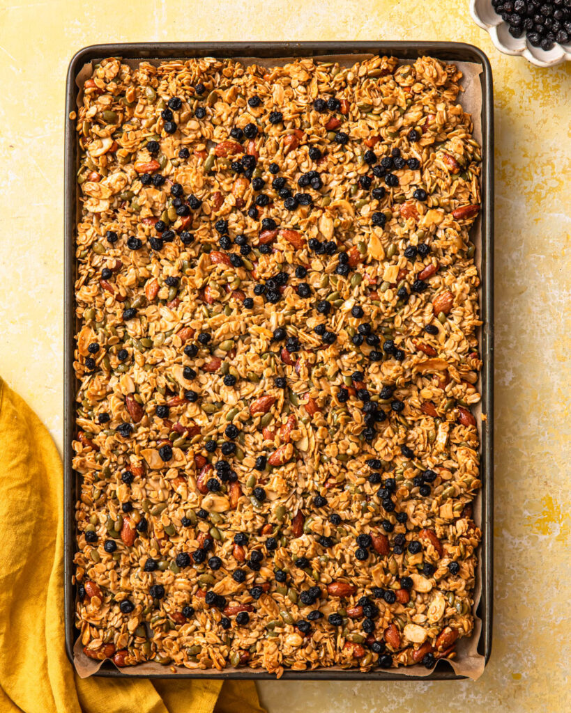 Baked lemon blueberry granola on a large baking tray.