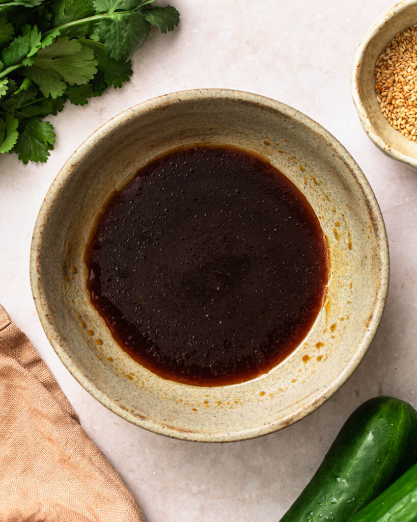 Dressing for sesame cucumber salad mixed together in a small bowl.