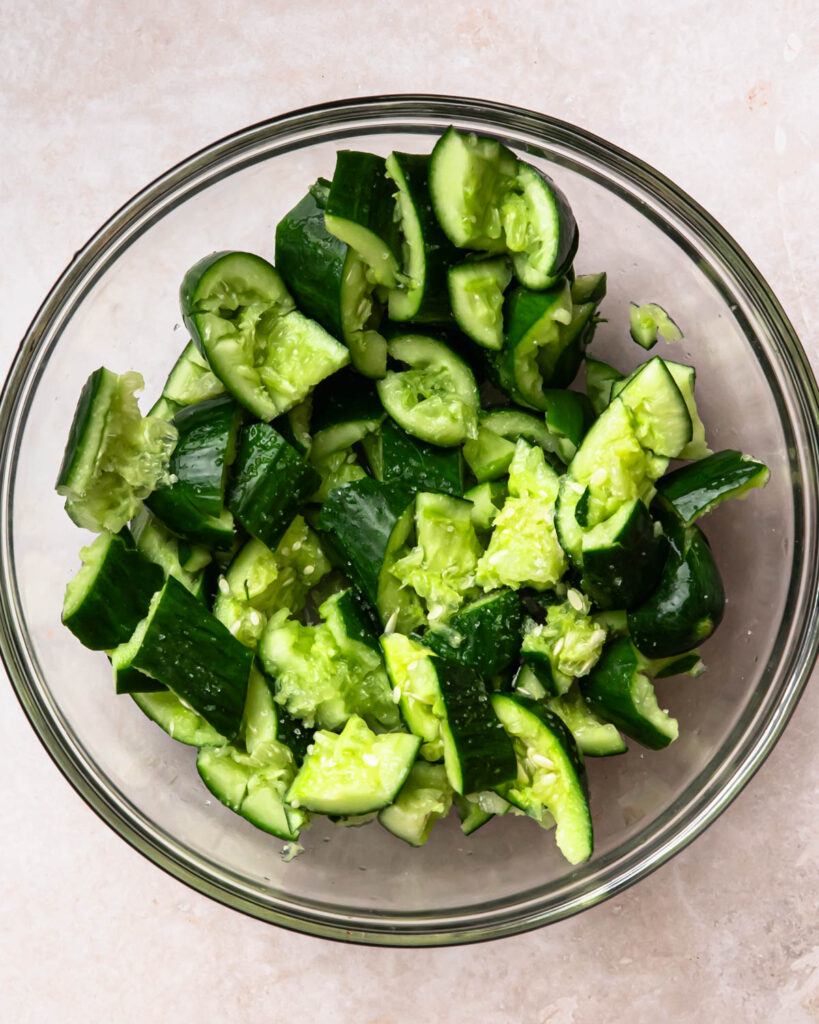 Roughly chopped smashed cucumbers topped with salt. 