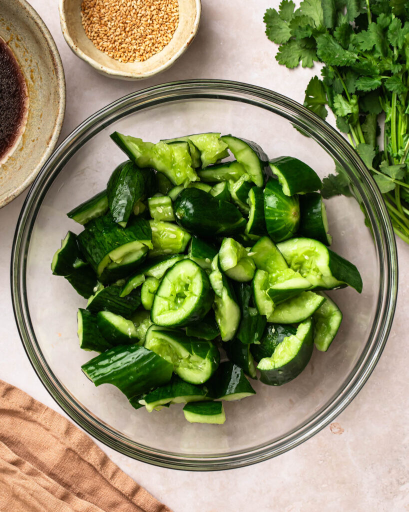 Roughly chopped smashed cucumbers topped with salt.