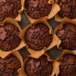 Baked gluten free chocolate zucchini muffins in a muffin tin.