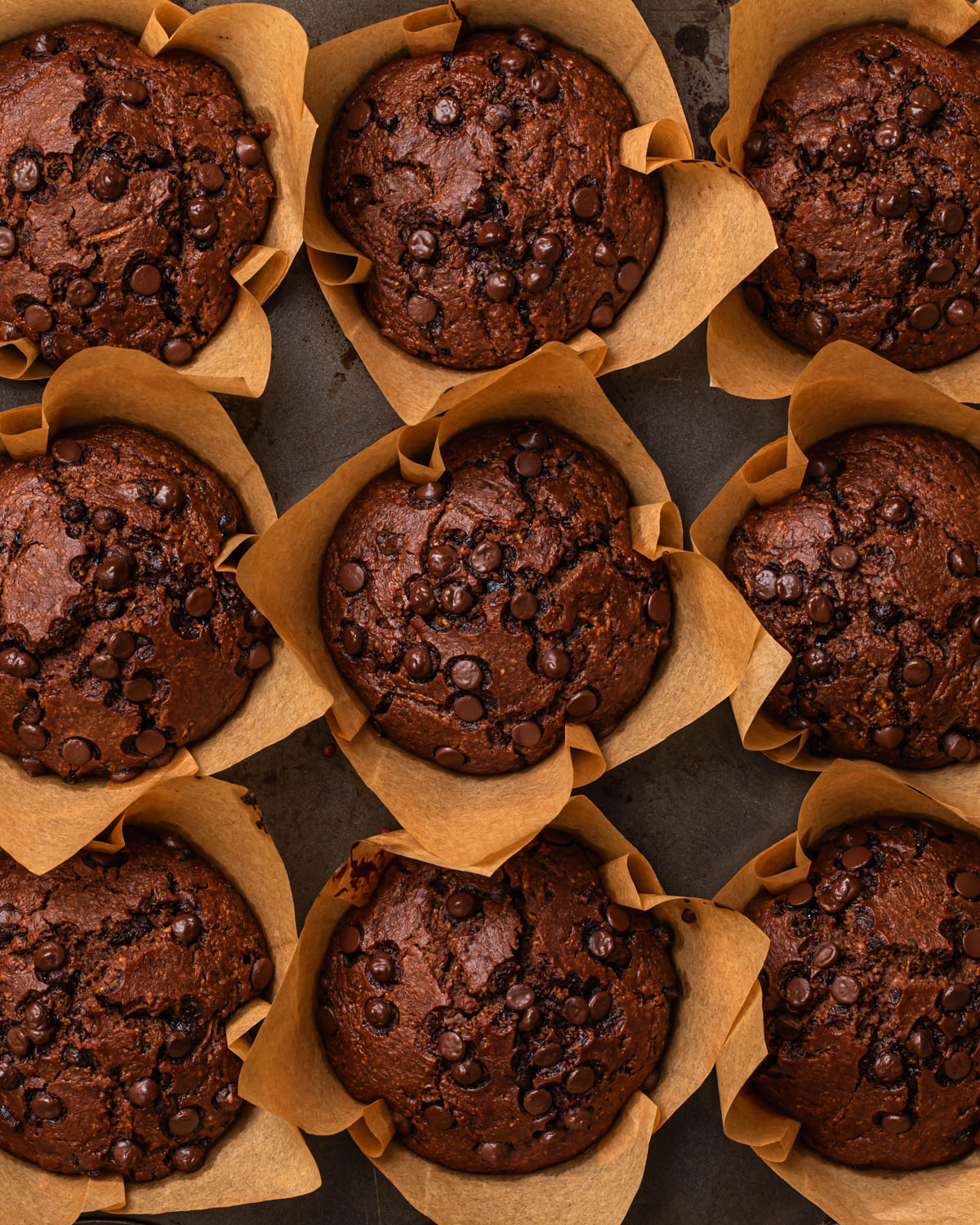 Baked gluten free chocolate zucchini muffins in a muffin tin.