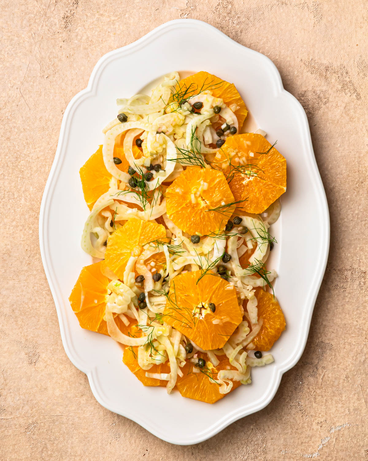 Orange and fennel salad arranged on a serving platter. 