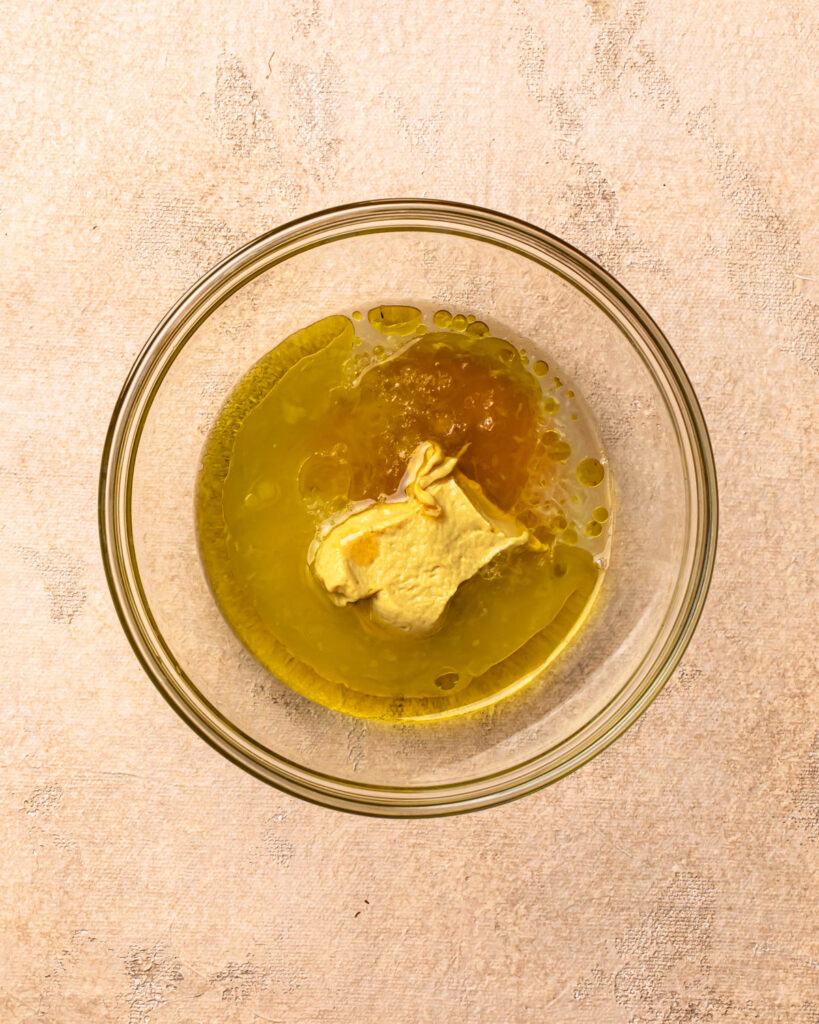 Ingredients for lemon dijon salad dressing in a bowl.