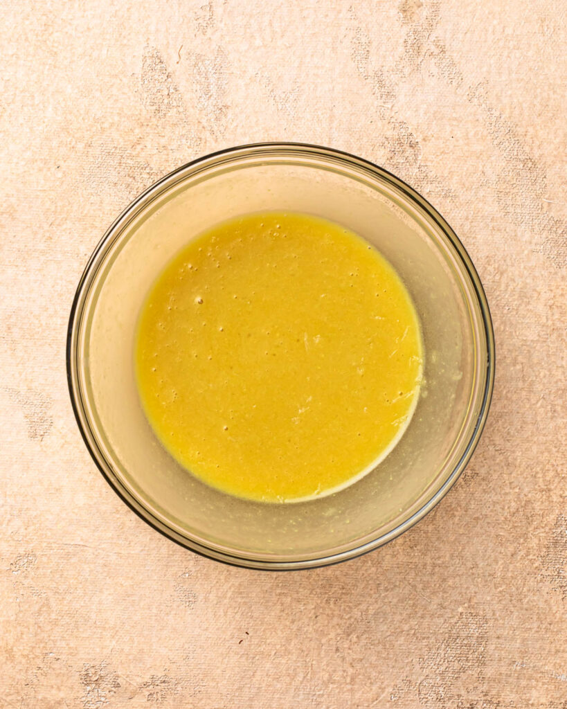 Lemon dijon salad dressing mixed together in a small bowl. 
