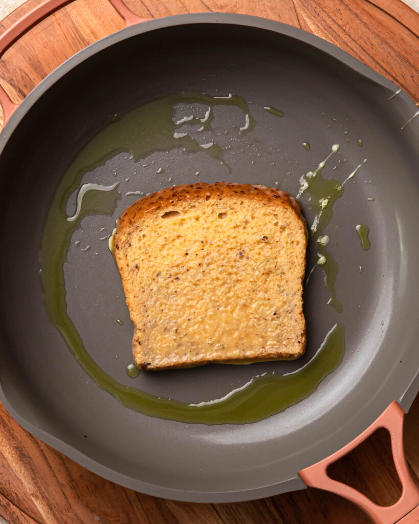Egg soaked bread frying in a pan.