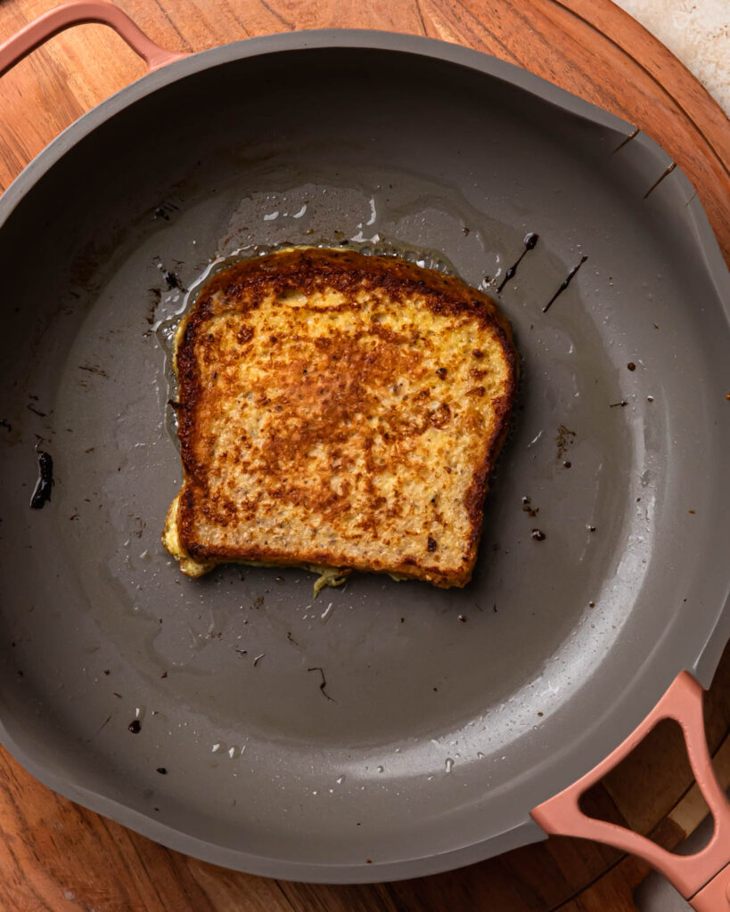 Savoury French toast frying in a pan.