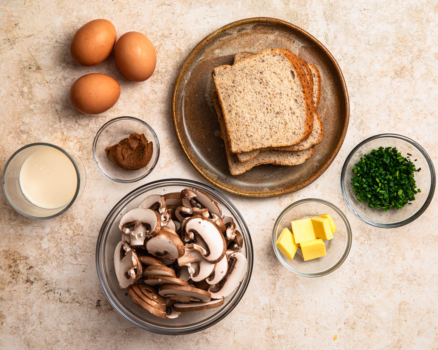 Ingredients for savoury French toast with miso butter mushrooms laid out in individual bowls. 
