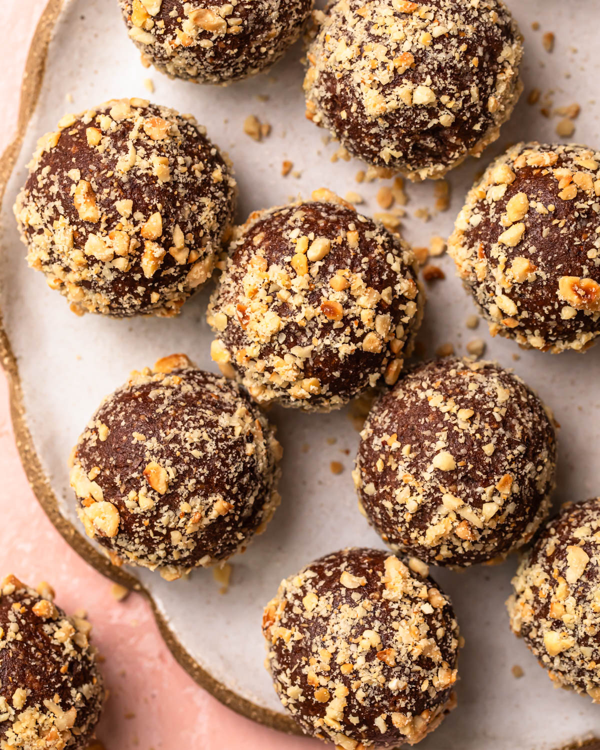 Close up photo of choc hazelnut no bake protein balls on a plate.