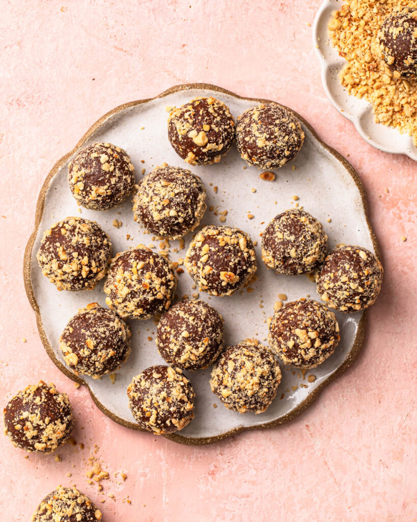 Choc hazelnut no bake protein balls on a plate.