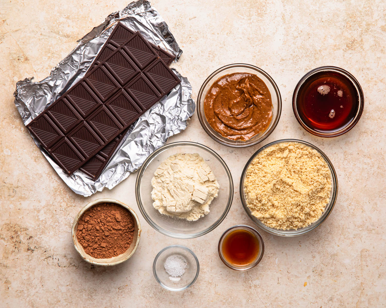 Ingredients for double chocolate protein balls laid out in individual bowls. 