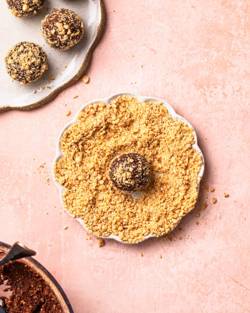 A no bake protein ball rolled in hazelnut meal.