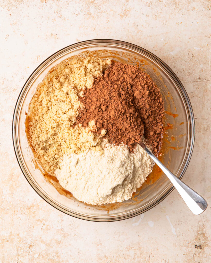 Dry ingredients added to the bowl of wet ingredients.