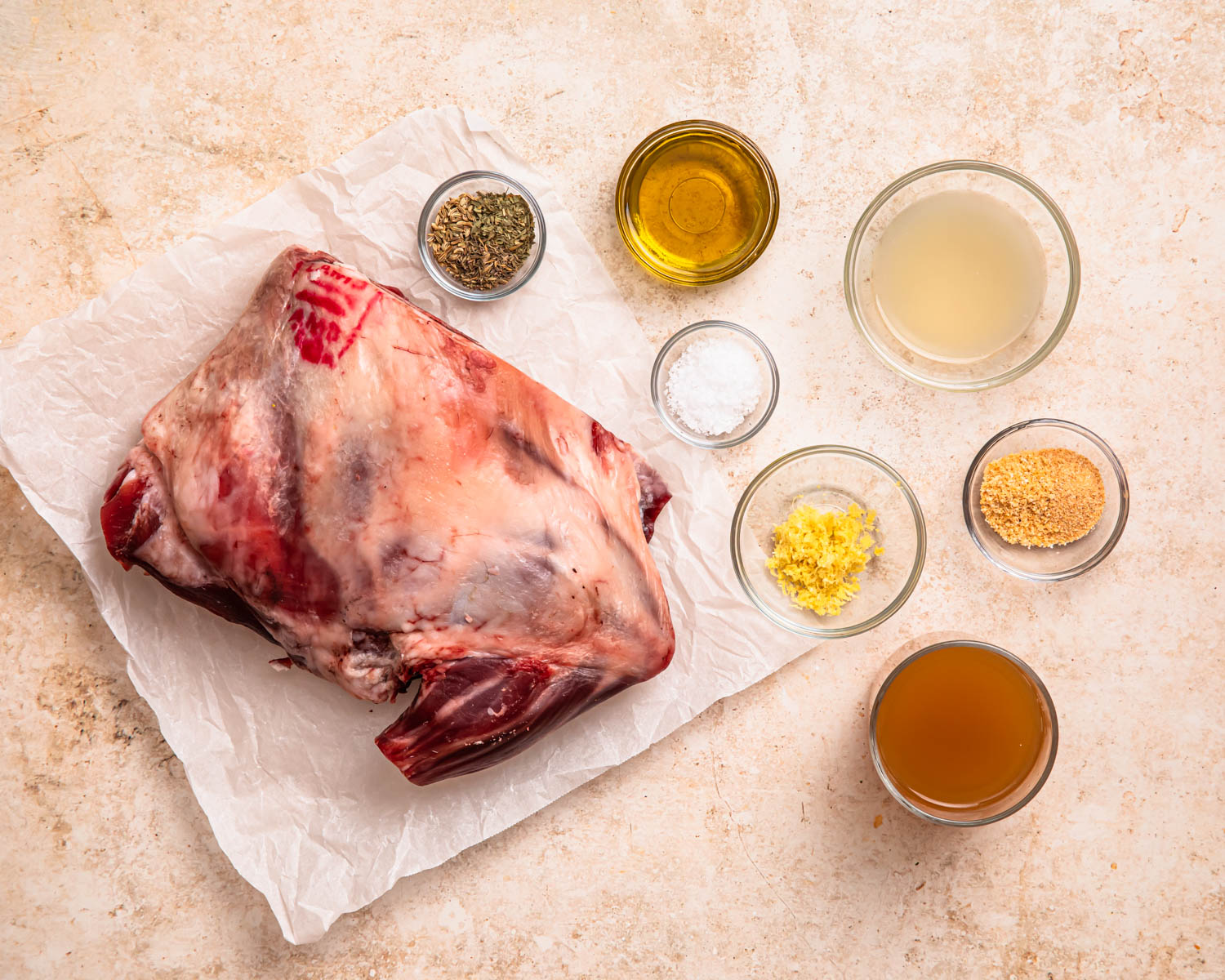 Ingredients for slow cooked lamb shoulder laid out in individual bowls.