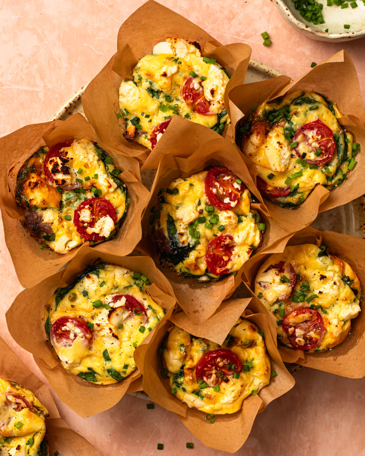 Photo of baked breakfast sausage egg cups placed onto a plate.