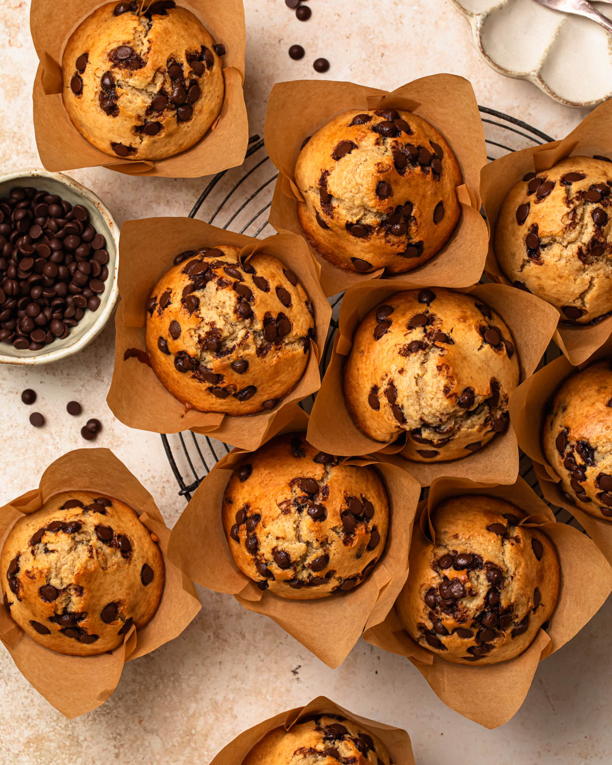 High protein choc chip muffins laid out on a cooling wrack.
