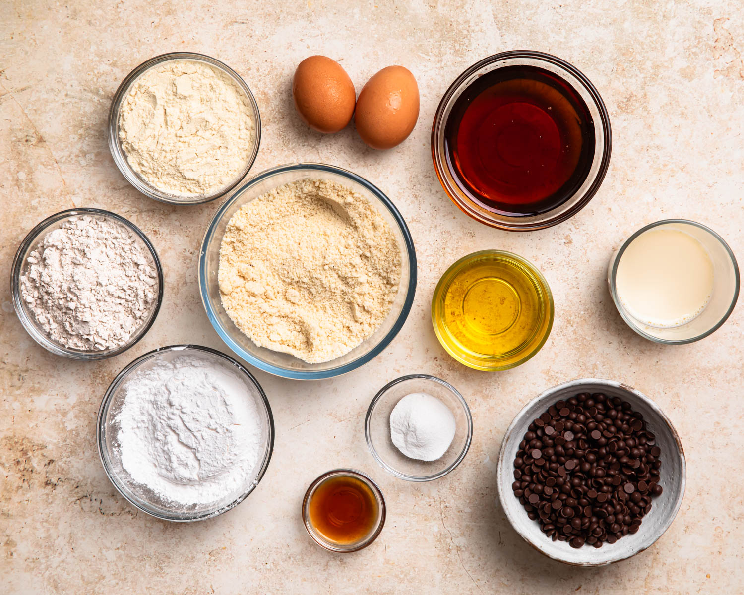 Ingredients for protein choc chip muffins laid out in individual bowls. 