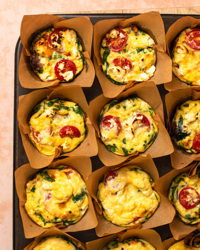 Baked breakfast sausage egg cups in a baking tin.