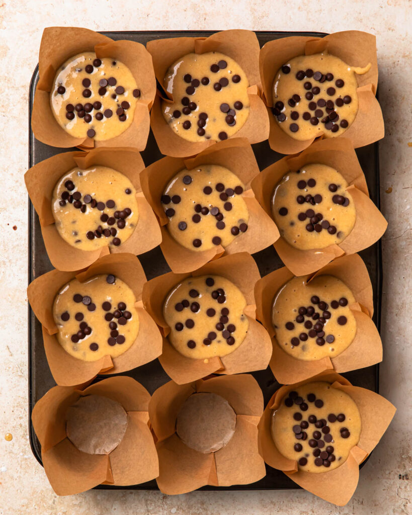 Uncooked protein choc chip muffins in a muffin tray. 