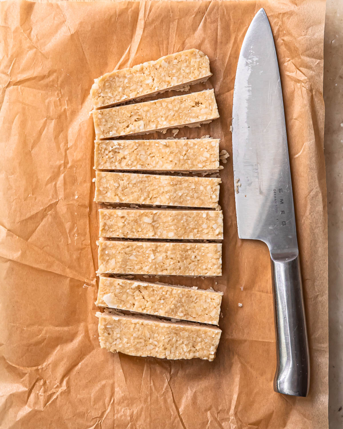 Frozen bounty bars filling cut into bars with a sharp knife.