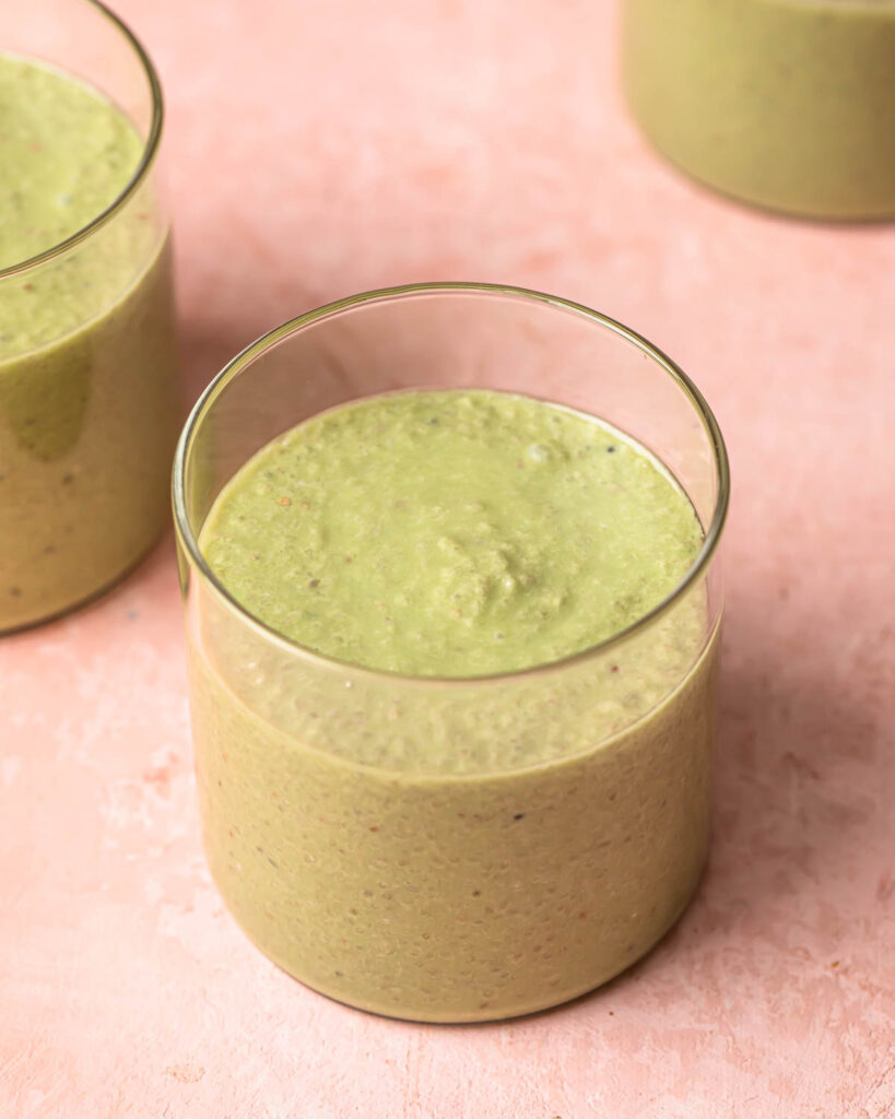 Matcha chia pudding divided into small glass jars. 
