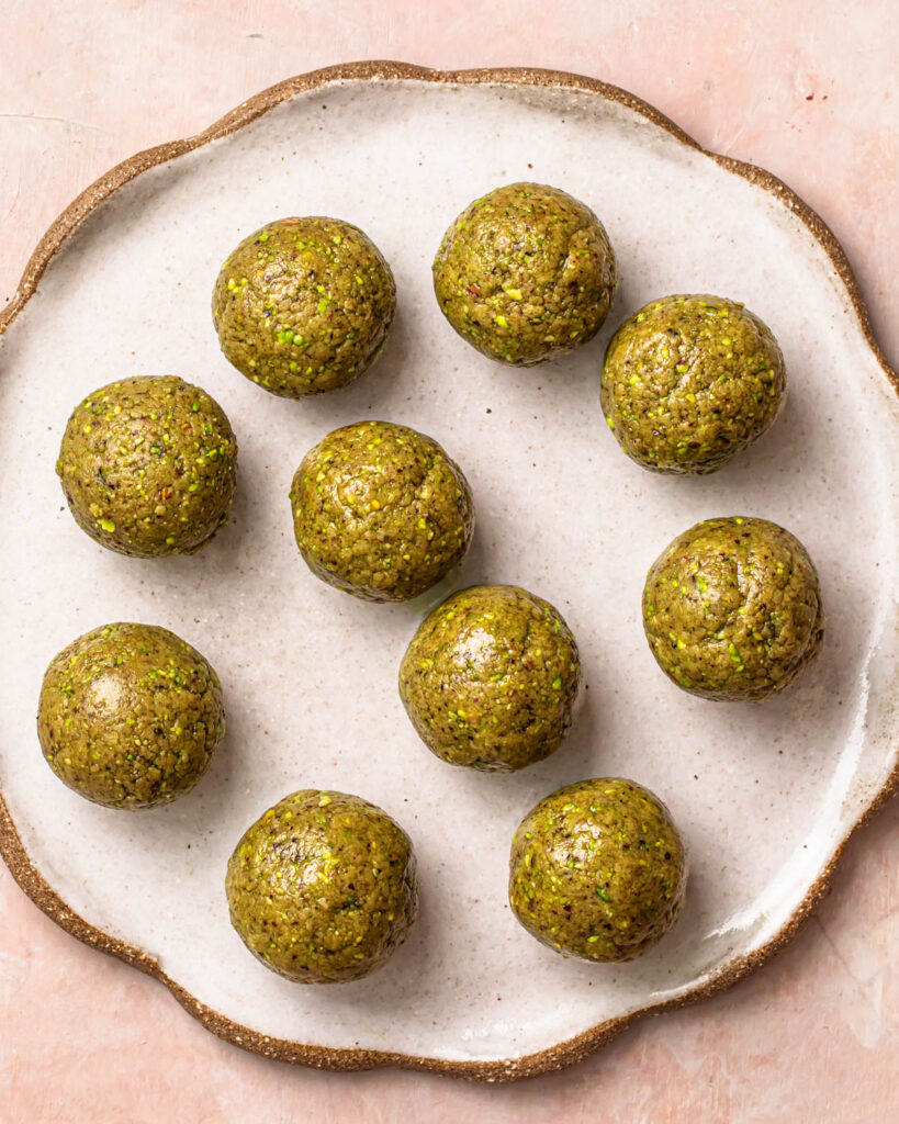 Pistachio protein balls on a plate.