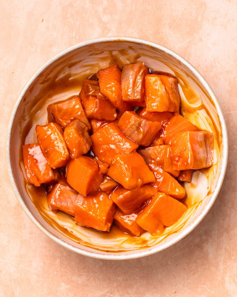 Salmon cubes marinaded in teriyaki sauce.