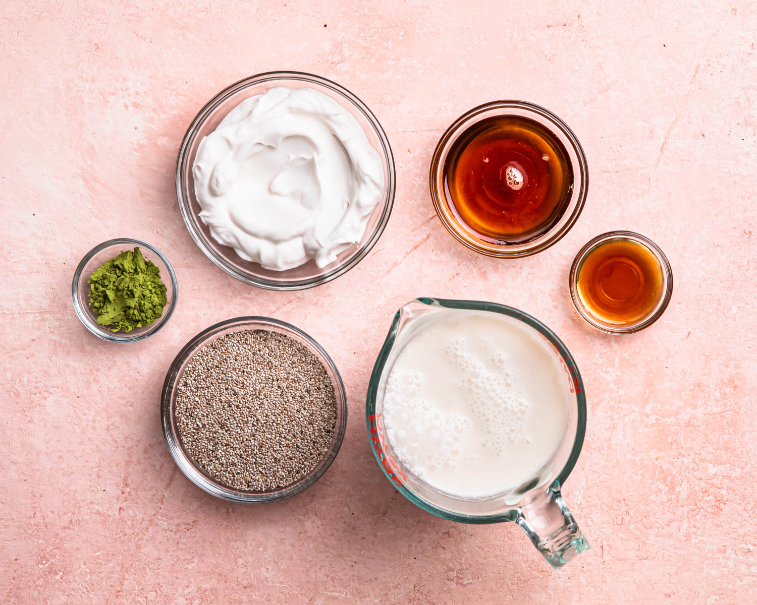Ingredients for matcha chia pudding laid out in individual bowls. 