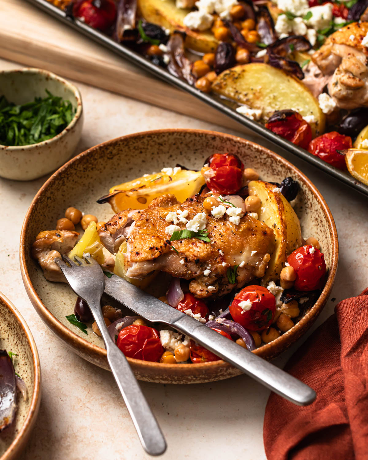 Mediterranean sheet pan chicken served in a bowl.