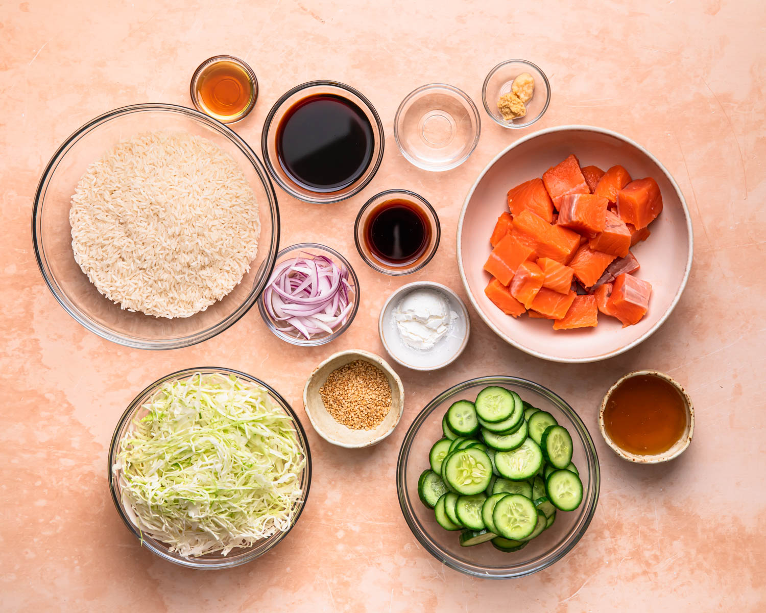 All of the ingredients for teriyaki salmon bowls laid out in individual bowls.