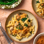 Chicken piccata pasta in a bowl topped with golden brown parmesan breadcrumbs.