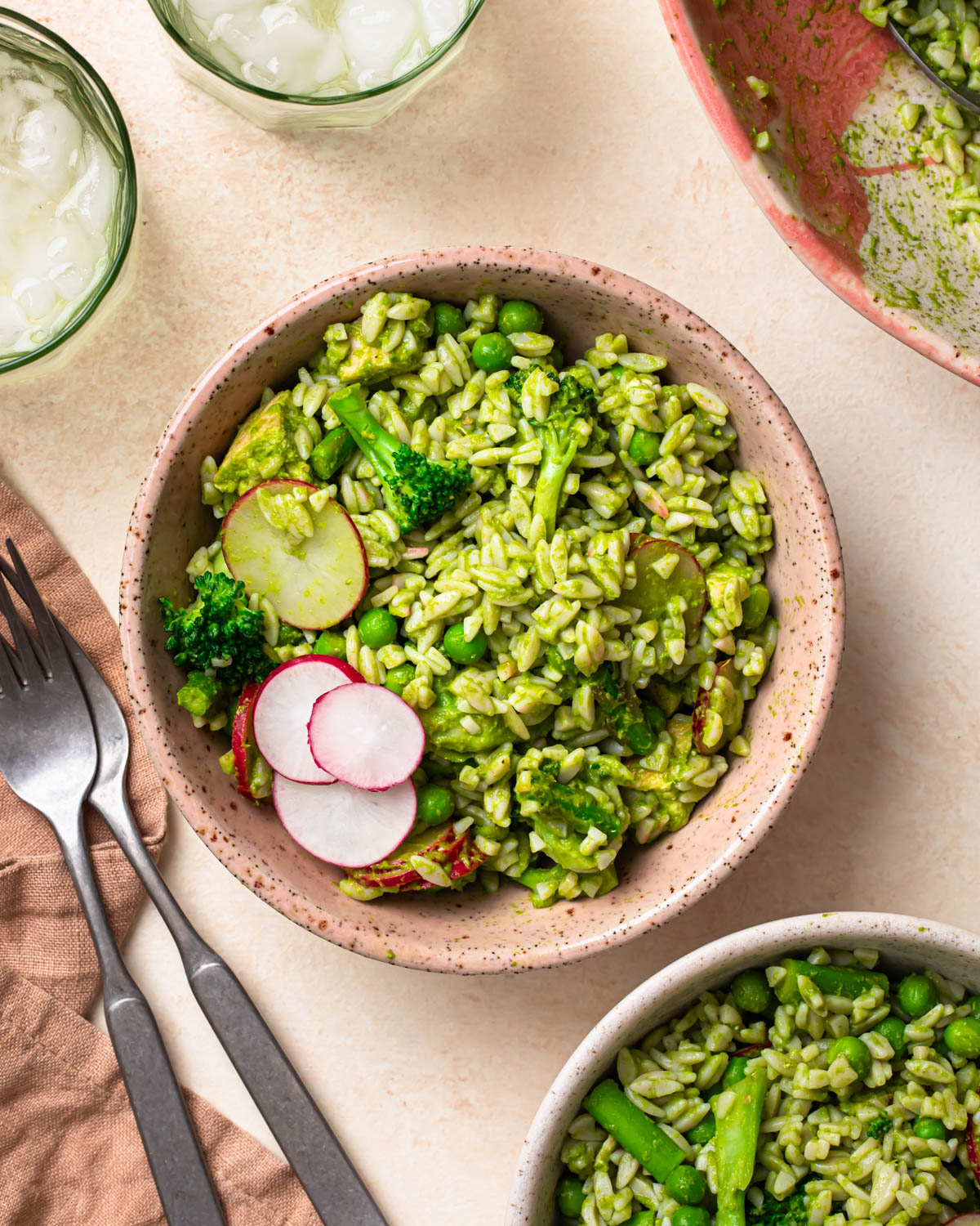Eat Your Greens Chicken Orzo Salad in served in a bowl, topped with fresh radish.