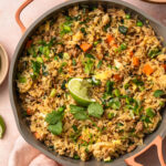 Ground pork fried rice in a pan topped with a lime wedge.
