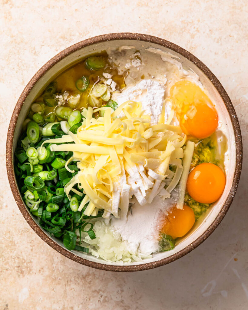 Ingredients for gluten free savoury muffins added to a bowl.
