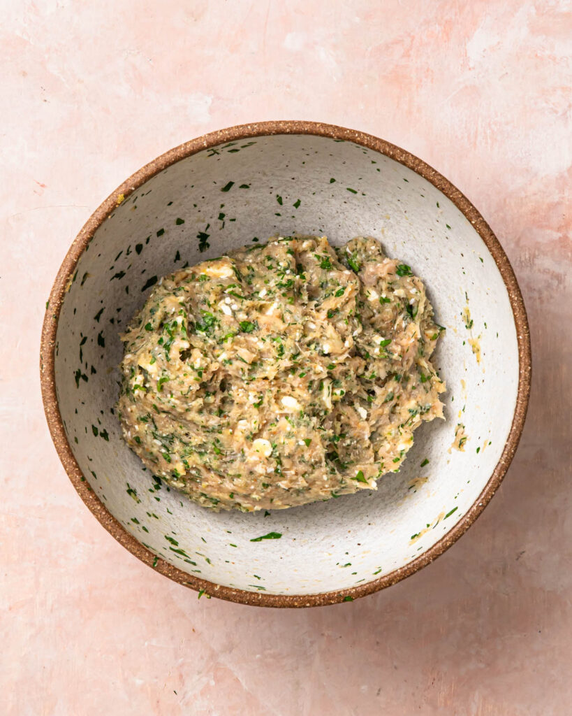 Greek chicken meatball mixture in a large bowl. 