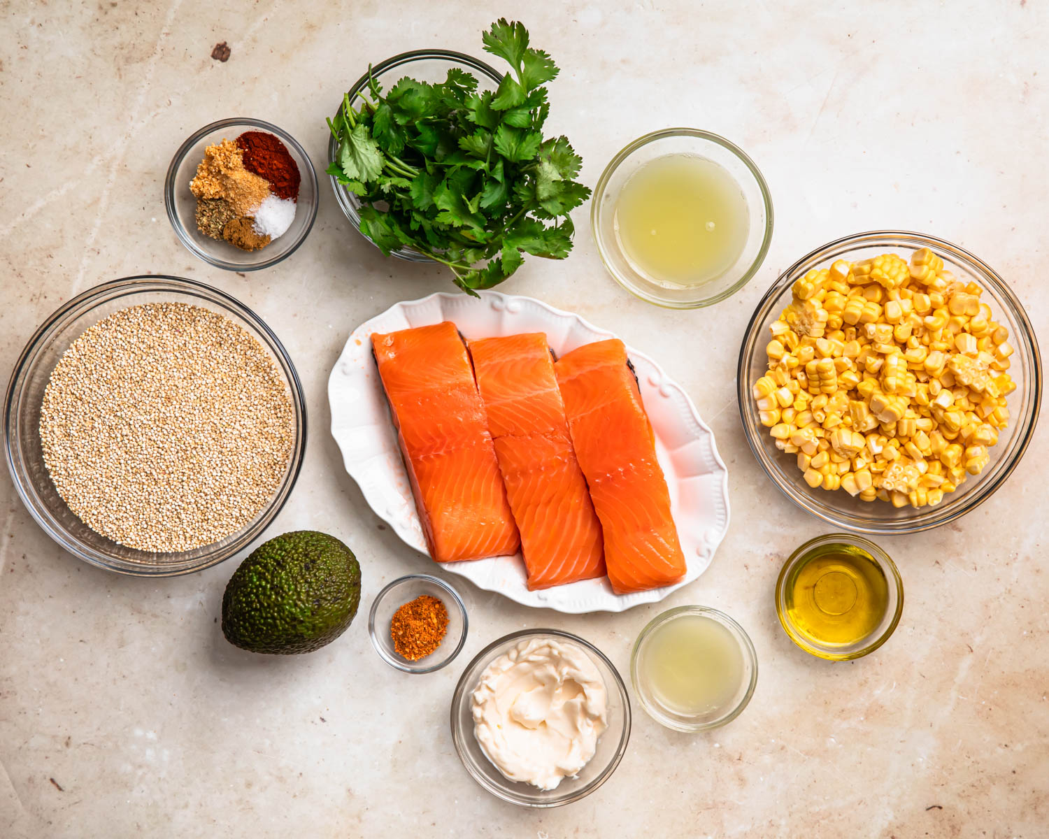 Ingredients for tex mex salmon quinoa bowls laid out in individual bowls. 