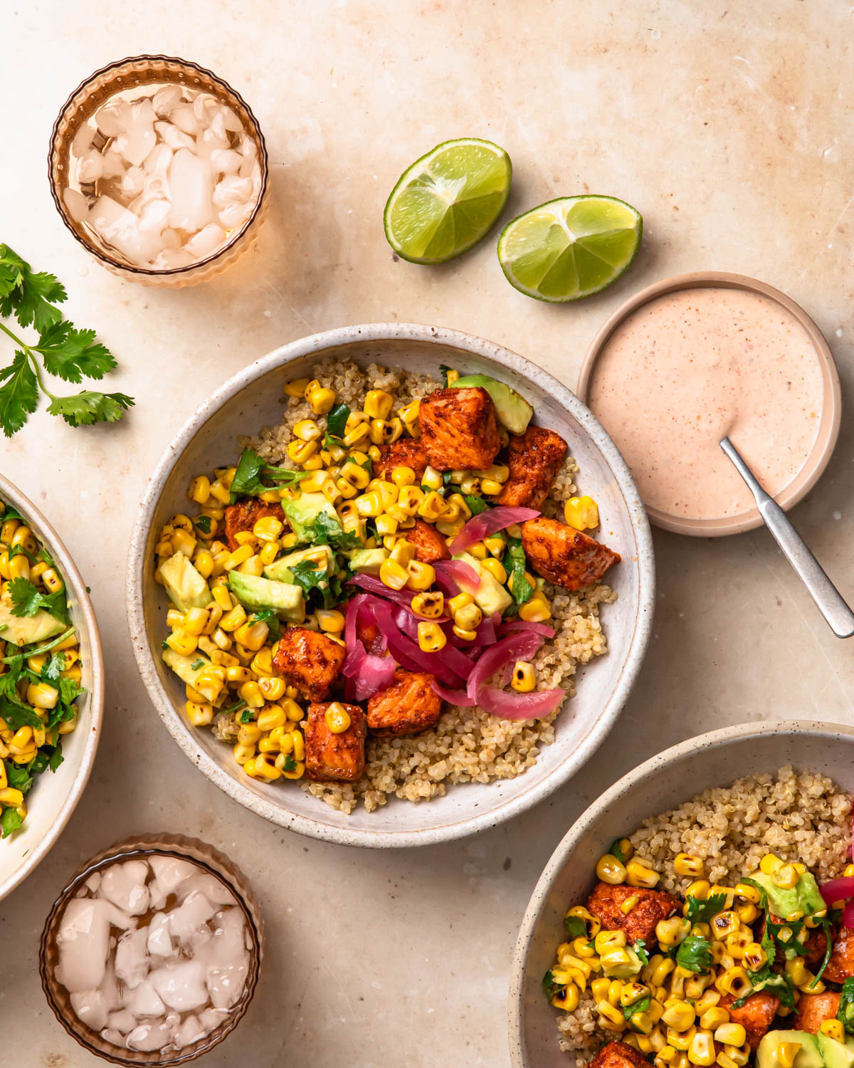 Tex mex salmon quinoa bowls topped with a wedge of lime.