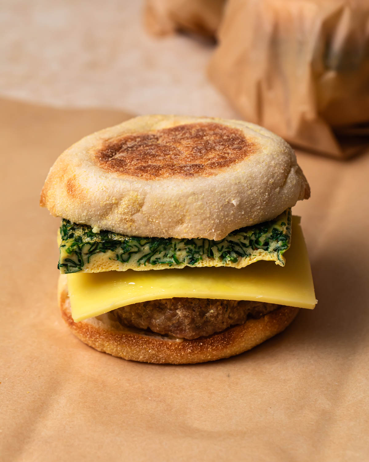Breakfast sausage sandwiches on a sheet of parchment paper. 