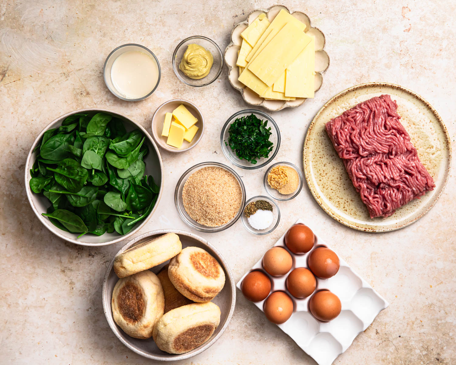 All of the ingredients to make breakfast sausage sandwiches, laid out in individual bowls. 