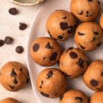Cookie dough protein balls on a plate.