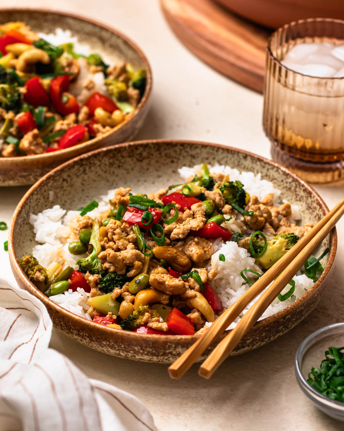 Ground chicken stir fry served in a bowl with chopsticks.