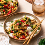 Ground chicken stir fry served in a bowl with chopsticks.