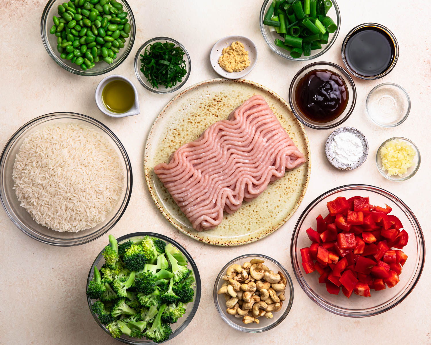 Ingredients for ground chicken stir fry laid out in individual bowls. 