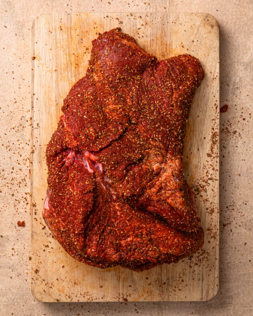 Beef brisket coated in dry rub.