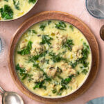 Chicken lemon rice soup in a bowl garnished with dill.