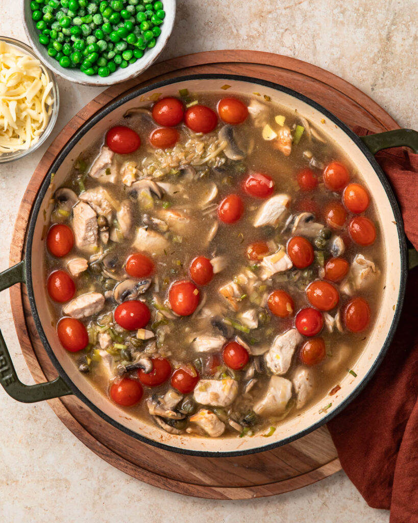 Chicken, tomatoes, broth and orzo in a shallow casserole pan.