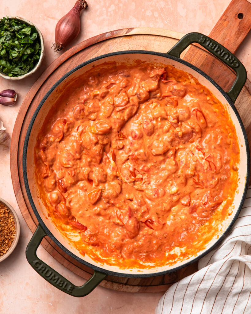 Creamy tomato goat cheese sauce in a skillet.