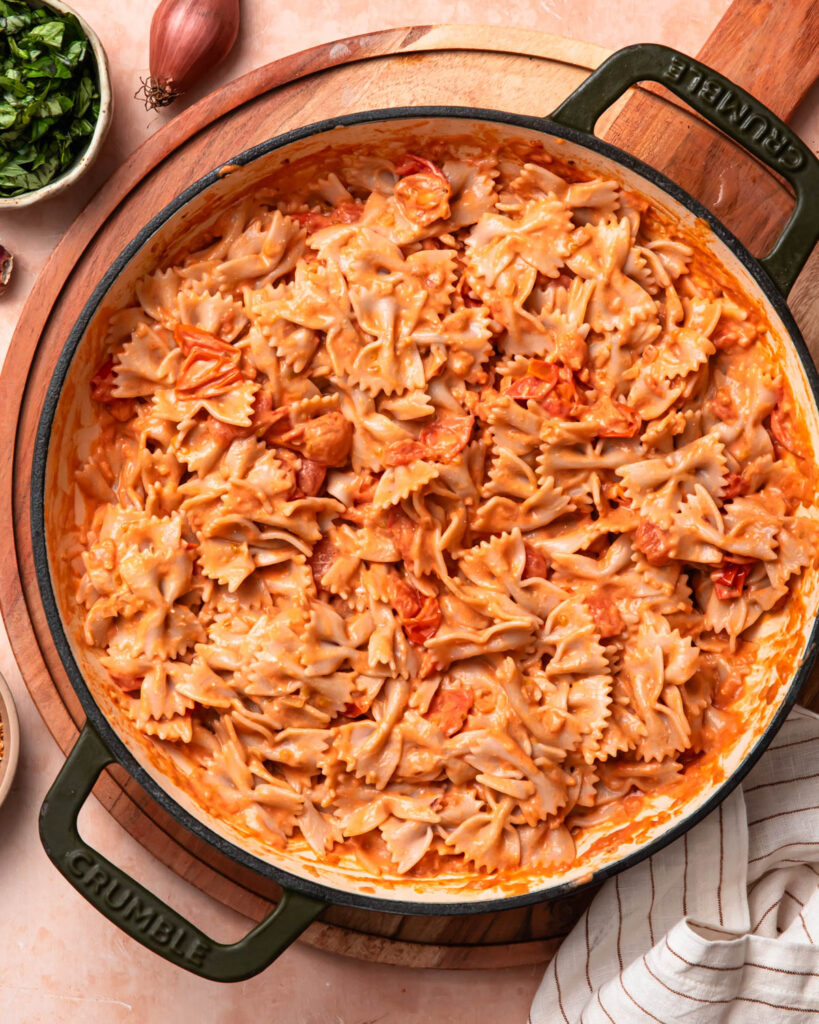 Bowtie pasta added to the tomato sauce.