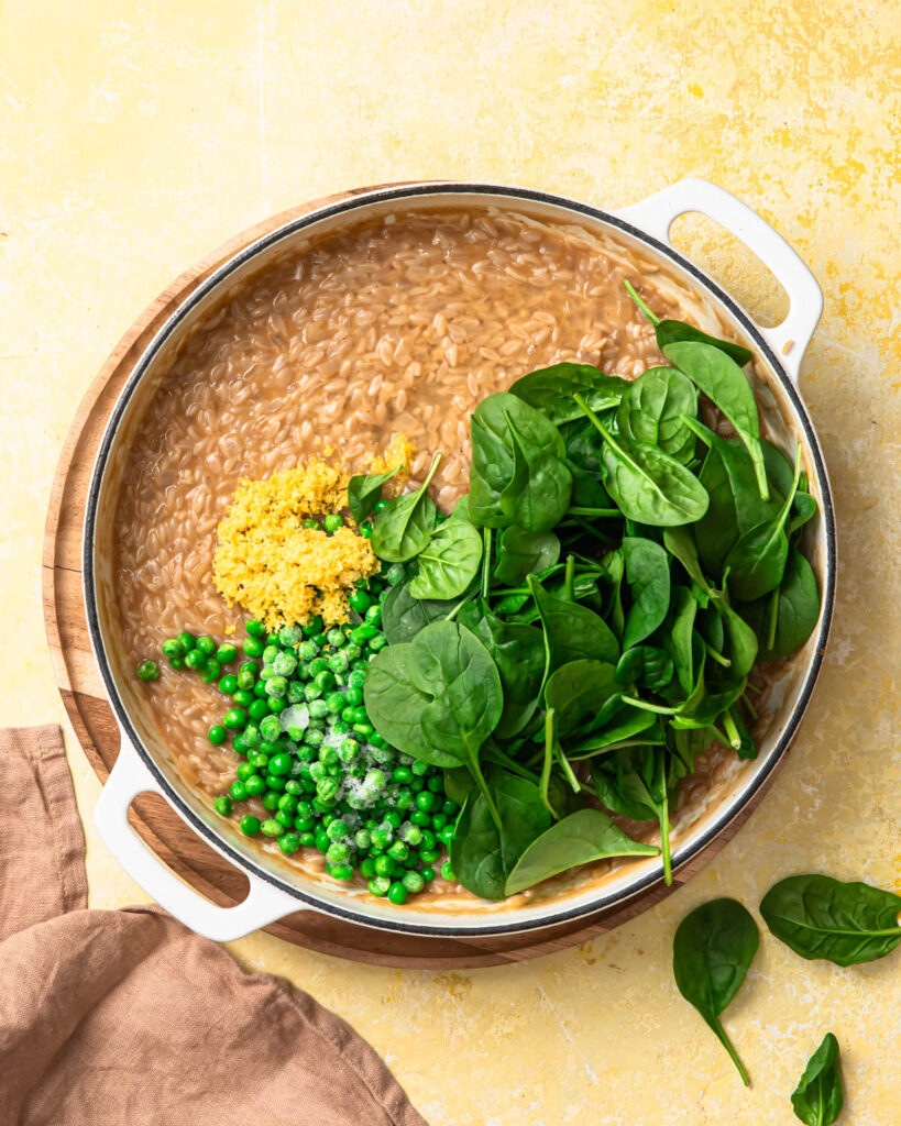 Peas and baby spinach added to lemon orzo.