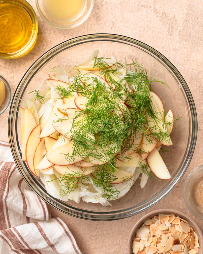 Ingredients for apple and fennel slaw in a bowl.